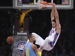 Philadelphia 76ers guard Ben Simmons, right, of Australia, dunks over Los Angeles Lakers forward Kyle Kuzma during the first half of an NBA basketball game, Wednesday, Nov. 15, 2017, in Los Angeles. (AP Photo/Mark J. Terrill)