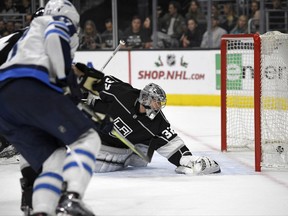 Winnipeg Jets center Adam Lowry, left, scores on Los Angeles Kings goalie Jonathan Quick during the first period of an NHL hockey game, Wednesday, Nov. 22, 2017, in Los Angeles. (AP Photo/Mark J. Terrill)