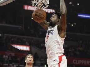 Los Angeles Clippers' DeAndre Jordan dunks as Los Angeles Lakers' Brook Lopez looks on during the first half of an NBA basketball game Monday, Nov. 27, 2017, in Los Angeles. (AP Photo/Jae C. Hong)