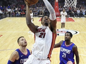Miami Heat center Hassan Whiteside, center, shoots as Los Angeles Clippers forward Blake Griffin, left, and guard Patrick Beverley defend during the first half of an NBA basketball game, Sunday, Nov. 5, 2017, in Los Angeles. (AP Photo/Mark J. Terrill)