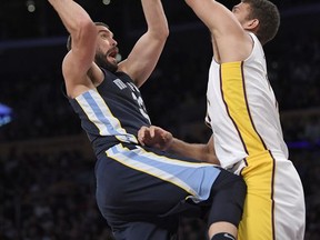 Memphis Grizzlies center Marc Gasol, left, of Spain, shoots as Los Angeles Lakers center Brook Lopez defends during the first half of an NBA basketball game, Sunday, Nov. 5, 2017, in Los Angeles. (AP Photo/Mark J. Terrill)