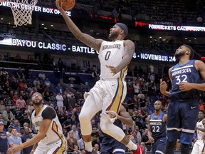 New Orleans Pelicans center DeMarcus Cousins (0) gets past Minnesota Timberwolves center Karl-Anthony Towns (32) for a shot in the second half of an NBA basketball game in New Orleans, Wednesday, Nov. 1, 2017. (AP Photo/Scott Threlkeld)