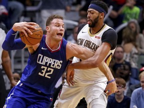 Los Angeles Clippers forward Blake Griffin (32) tries to get past New Orleans Pelicans forward Anthony Davis (23) during the first half of an NBA basketball game in New Orleans, Saturday, Nov. 11, 2017. (AP Photo/Scott Threlkeld)