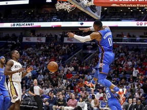 Oklahoma City Thunder's Russell Westbrook (0) dunks as New Orleans Pelicans guard Rajon Rondo (9) trails the play in the first half of an NBA basketball game in New Orleans, Monday, Nov. 20, 2017. (AP Photo/Scott Threlkeld)