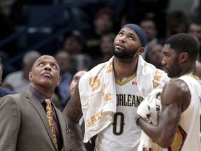 New Orleans Pelicans head coach Alvin Gentry and center DeMarcus Cousins (0) watch the replay of Cousins elbowing Oklahoma City Thunder guard Russell Westbrook (0) in the head in the second half of an NBA basketball game in New Orleans, Monday, Nov. 20, 2017. Cousins was ejected for the play. The Pelicans won 114-107. (AP Photo/Scott Threlkeld)