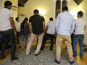 In this July 27, 2017, photo, Sri Lankans, many of whom said they were tortured in their home country, gather at a church in London. Sri Lankan torture victims seeking asylum in Europe travel to London each week for English classes, counseling sessions and lunch. Sometimes, human rights investigators meet new victims willing to give their testimonies. (AP Photo/Frank Augstein)