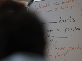In this July 27, 2017, photo, Sri Lankans, many of whom said they were tortured in their home country, attend an English class in London. Sri Lankan torture survivors seeking asylum in Europe travel to London each week for English classes, counseling sessions and lunch. Sometimes, human rights investigators meet new victims willing to give their testimonies. (AP Photo/Frank Augstein)