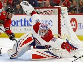 Charlie Lindgren of the Montreal Canadiens corrals a loose puck at the side of the goal against the Chicago Blackhawks in NHL action Sunday night in Chicago. Lindgren had 38 saves to record his first career shutout in a 2-0 victory over the Blackhawks.