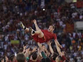 FILE - In this Sunday, May 28, 2017 file photo, Roma's Francesco Totti is tossed in the air by his teammates after an Italian Serie A soccer match against Genoa at the Olympic stadium in Rome. Less than a week after Italy's failed qualification for the World Cup, Serie A returns with a big weekend. Six of the top seven teams play one another, highlighted by Roma playing Lazio in the Rome derby, their first derby since longtime Roma captain Francesco Totti retired, on Saturday, Nov. 18 and leader Napoli's match against AC Milan. (AP Photo/Alessandra Tarantino, file)