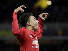 Manchester United's Jesse Lingard celebrates scoring his side's fourth goal during the English Premier League soccer match between Watford and Manchester United at Vicarage Road stadium in Watford, England, Tuesday, Nov. 28, 2017. (AP Photo/Matt Dunham)