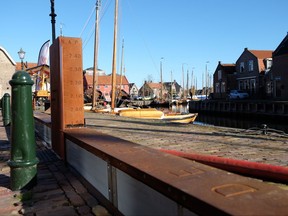 In this Nov. 6, 2017, photo, a self-raising dike is seen in the Dutch fishing village of Spakenburg. The 300-meter long dike that is raised by the very flood waters it is designed to hold back is an example of Dutch ingenuity in flood prevention that is becoming a major export earner for this low-lying nation. (AP Photo/Mike Corder)
