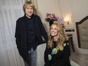 In this photo taken on Sunday, Nov. 5, 2017, actors Owen Wilson, left and Julia Roberts pose for a portrait photograph while promoting the film "Wonder" in London. "Wonder" could have been designed as an antidote to the headlines. It's a thoroughly positive movie about the importance of kindness. Based on R.J. Palacio's best-selling kids' novel, the movie follows Auggie Pullman, a boy with a craniofacial deformity, as he takes his first anxious steps into an intimidating world. (Photo by Vianney Le Caer/Invision/AP)