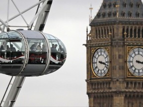 FILE - In this file photo dated Tuesday, Feb. 21, 2017, visitors enjoy the view from a pod on the London Eye overlooking Big Ben's clock tower and the Houses of Parliament in London.  Many British businesses are trying to gauge the impact of the country's looming Brexit departure from the European Union, but the tourism industry is enjoying a "Brexit bounce" according to official figures released Friday Nov. 17, 2017, revealing a 5 percent increase on a year earlier. (AP Photo/Frank Augstein, FILE)