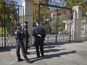 FILE - In this Monday, Oct. 16, 2017 file photo, police stand in front of the residence of Ivica Todoric, founder of the Croatia's biggest private company, as others raid his home in Zagreb. A prominent Croatian businessman was arrested in Britain on Tuesday, Nov. 7, 2017 a warrant issued by Croatian authorities, London police said. Police said that 66-year-old Ivica Todoric, the founder of Croatia's biggest private food and retail company Agrokor, will appear in Westminster Magistrates' Court later in the day.  (AP Photo/Darko Bandic, file)