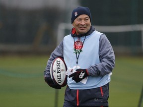 FILE - This is a Tuesday, Feb. 14, 2017 file photo of England's head coach Eddie Jones as he smiles during an England rugby union team training session at a school in London. One of rugby's fiercest rivalries was briefly set aside when England and Wales joined for a training session on Monday Nov. 6, 2017, to hone their set-pieces ahead of the autumn international series. England forwards coach Steve Borthwick brokered an unprecedented arrangement between the two nations for a 40-minute practice session in Bristol, a city located approximately halfway between the rivals' training bases.  (AP Photo/Alastair Grant/File)