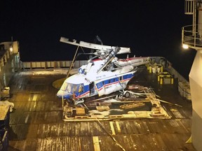 In this photo provided by The Accident Investigation Board Norway, the body, rotor and separated tail of the helicopter MI-8AMT with the registration RA-22312 is lifted up on deck of the ship Maersk Forza, off the coast of Svalbard, Norway, early Saturday, Nov. 4, 2017. A Russian helicopter that crashed off Norway's Arctic Svalbard archipelago with eight people onboard last month has been raised from the seabed.  Norway's Accident Investigation Board says none of the missing people were inside the helicopter that went down Oct. 26 near the Svalbard settlement of Barentsburg. (The Accident Investigation Board Norway via AP)
