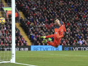 Southampton goalkeeper Fraser Forster dives as Liverpool's Mohamed Salah scores his side's first goal of the game during the English Premier League soccer match Liverpool versus Southampton at Anfield, Liverpool, England, Saturday Nov. 18, 2017. (Peter Byrne/PA via AP)