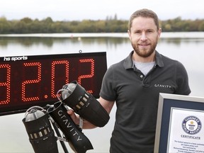 Richard Browning poses for the media after setting the Guinness World Record for 'the fastest speed in a body-controlled jet engine power suit', at Lagoona Park in Reading, England, Thursday, Nov. 9, 2017. A British inventor billed as a real-life version of the superhero Iron Man has hit the fastest speed in a body-controlled jet engine power suit at 32 mph (51 kph) to set a new Guinness world record. The record keeper announced Tuesday's feat on Thursday as part of its annual Guinness World Records day. (Matt Alexander/PA via AP)