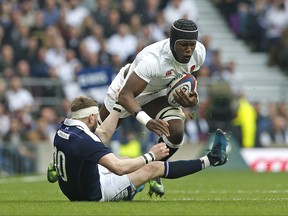 FILE - In this Saturday, March 11, 2017 file photo, England's Maro Itoje, background, clatters into Scotland's Finn Russell during the Six Nations rugby union international between England and Scotland at Twickenham stadium in London. Itoje has been named on a five-man shortlist for the 2017 Rugby Player of the year award, it was reported on Monday, Nov. 13, 2017. (AP Photo/Alastair Grant, File)