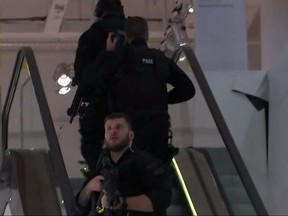 In this grab taken from video, armed police patrol a department store, near to Oxford Street, in London, Friday, Nov. 24, 2017.  British police said Friday they were responding to reports of an incident at Oxford Circus subway station, one of London's busiest. (AP)