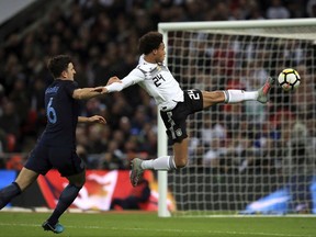 Germany's Leroy Sane, right, controls the ball under pressure from England's Harry Maguire during the international friendly soccer match between England and Germany at Wembley stadium in London, Britain, Friday, Nov. 10, 2017. (Mike Egerton/PA via AP)