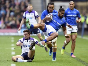 Scotland's Lee Jones, left, catches Samoa's Ah See Tuala by the foot during a rugby union international match at BT Murrayfield, Edinburgh, Scotland, Saturday Nov. 11, 2017. (Ian Rutherford/PA via AP)