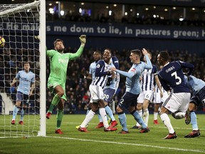 Newcastle United's Ciaran Clark, center, scores his side's first goal against West Bromwich Albion during the English Premier League soccer match at The Hawthorns, West Bromwich, England, Tuesday Nov. 28, 2017. (David Davies/PA via AP)