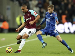West Ham United's Winston Reid, left and Leicester City's Jamie Vardy vie for the ball, during the English Premier League soccer match between West Ham United and Leicester City,  at the London Stadium, in London, Friday Nov. 24, 2017. (Adam Davy/PA via AP)