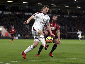 Burnley's Chris Wood, left, and AFC Bournemouth's Steve Cook in action during their English Premier League soccer match at the Vitality Stadium in Bournemouth, England, Wednesday Nov. 29, 2017. (Steven Paston/PA via AP)