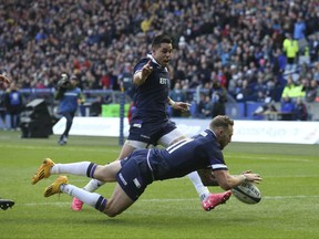 Scotland's Byron McGuigan dives in to score his sides first try against Australia, during the Autumn International rugby union match at Murrayfield Stadium in Edinburgh, Scotland, Saturday Nov. 25, 2017. (Andrew Milligan/PA via AP)