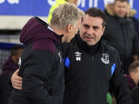Everton caretaker manager David Unsworth, right, and West Ham manager David Moyes talk prior to the English Premier League soccer match at Goodison Park, Liverpool, England, Wednesday Nov. 29, 2017. (Peter Byrne/PA via AP)