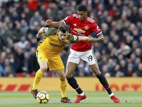 Brighton & Hove Albion's Pascal Gross, left, and Manchester United's Marcus Rashford in action during the English Premier League soccer match at Old Trafford in Manchester, England, Saturday Nov. 25, 2017. (Martin Rickett/PA via AP)