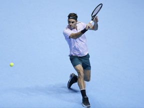 Roger Federer of Switzerland plays a return to David Goffin of Belgium during their ATP World Tour Finals semifinal tennis match at the O2 Arena in London, Saturday Nov. 18, 2017. (AP Photo/Tim Ireland)