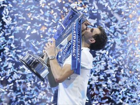 Grigor Dimitrov of Bulgaria lifts the trophy after defeating David Goffin of Belgium in their ATP World Tour Finals singles final tennis match at the O2 Arena in London, Sunday Nov. 19, 2017. (AP Photo/Tim Ireland)