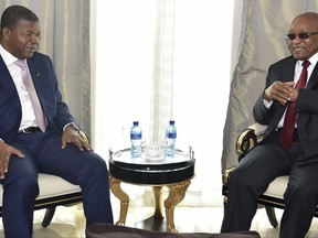 In this photo supplied by South African Communication and Information Services (GCIS), Angolan President Joao Lourenco, left, and his South African counterpart Jacob Zuma, meet in Luanda, Angola, Tuesday, Nov. 21 2017.  Zuma is in Angola as head of the inter-governmental organization SADC (Southern African Development Community) to discuss the situation in Zimbabwe. (Elmond Jiyane, GCIS, via AP)