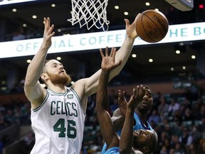 Boston Celtics' Aron Baynes (46) and Charlotte Hornets' Michael Kidd-Gilchrist (14) battle for a rebound during the first quarter of an NBA basketball game in Boston, Friday, Nov. 10, 2017. (AP Photo/Michael Dwyer)