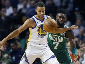 Boston Celtics' Jaylen Brown, right, and Golden State Warriors' Stephen Curry, left, battle for a loose ball during the first quarter of an NBA basketball game in Boston, Thursday, Nov. 16, 2017. (AP Photo/Michael Dwyer)