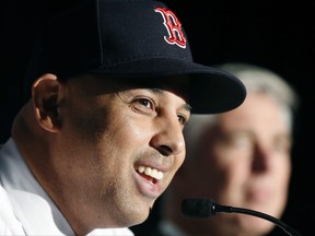 Alex Cora, left, smiles beside Boston Red Sox President of Baseball Operations Dave Dombrowski, during a news conference where Cora was introduced as the Red Sox baseball teams new manager, Monday, Nov. 6, 2017, in Boston.  (AP Photo/Michael Dwyer)