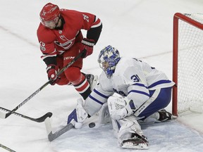 Toronto Maple Leafs goalie Frederik Andersen blocks Carolina Hurricanes' Elias Lindholm during the third period of their game in Raleigh, N.C., on Friday night.