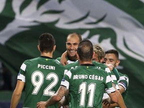 Sporting's Bas Dost, background center, celebrates with team mates after scoring his side's opening goal during a Champions League, Group D soccer match between Sporting CP and Olympiakos at the Alvalade stadium in Lisbon, Wednesday Nov. 22, 2017. (AP Photo/Armando Franca)