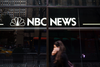 A pedestrian walks past the NBC News studios, Nov. 29, 2017 in New York City.