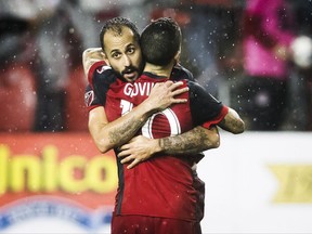 Toronto FC's Victor Vazquez and Sebastian Giovinco embrace after defeating the New York Red Bulls on away goals to win the MLS Eastern Conference semifinal in Toronto on Sunday, November 5, 2017. THE CANADIAN PRESS/Mark Blinch