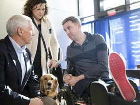 Vice President Mike Pence talks with Staff Sgt. Liam Dwyer, 36, of the 3rd Battalion 5th, Marine Regiment, Camp Pendleton, and his wife Meghan, during a visit with patients and their families and care providers at the USO Warrior and Family Center at Walter Reed National Military Medical Center in Bethesda, Md. Wednesday, Nov. 22, 2017. (AP Photo/Carolyn Kaster)