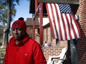 Sabein Burgess stands outside his mother's home in Baltimore, Wednesday, Nov. 22, 2017. A federal jury awarded $15 million to Burgess Tuesday in his lawsuit against the Baltimore Police Department and two detectives. Burgess, who spent nearly two decades in prison after being wrongfully convicted of killing his girlfriend, was released in 2015 after being exonerated. (AP Photo/Patrick Semansky)