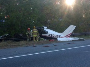 This photo released by the Anne Arundel County Fire Department shows emergency officials responding to a plane crash on Interstate 97 near Annapolis, Md., Friday, Nov. 10, 2017. Fire officials said no one was hurt. (Anne Arundel County Fire Department via AP)