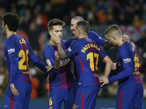 FC Barcelona's Paco Alcacer, 17, center, is congratulated by teammates after scored during a Spanish Copa del Rey round of 32 second leg soccer match between FC Barcelona and Murcia at the Camp Nou stadium in Barcelona, Wednesday, Nov 29, 2017. (AP Photo/Manu Fernandez)