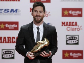 FC Barcelona's Lionel Messi poses after receiving his fourth Golden Shoe award for leading all of Europe's leagues in scoring last season in Barcelona, Spain, Friday, Nov 24, 2017. Messi scored 37 goals in the Spanish league last season. It was the fourth time the Barcelona forward has received the honor. (AP Photo/Manu Fernandez)