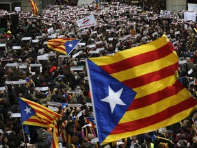 Thousands of people rally outside the regional presidential palace in Sant Jaume Square during a general strike in Barcelona, Spain, Wednesday, Nov. 8, 2017. A worker's union has called for a general strike Wednesday in Catalonia. The regional government was sacked by Madrid and many of its members jailed in a rebellion probe after pushing ahead with secession from Spain. (AP Photo/Manu Fernandez)