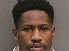 This booking photo provided by the Tampa Police Department, Fla., on Wednesday, Nov. 29, 2017, shows Howell Emanuel Donaldson. Donaldson, the suspect in a string of four slayings that terrorized a Tampa neighborhood was arrested after he brought a loaded gun to his job at a McDonald's and asked a co-worker to hold it, authorities said.  (Tampa Police Department via AP)