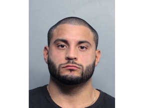 This photo made available by the Miami Dade Police Department shows 32-year-old Michael Arana under arrest, Thursday, Nov. 30, 2017 in Miami. Arana is the head of security for singer Justin Bieber. He was arrested in Miami following a car crash that injured two police officers. (Miami Dade Police Department via AP)